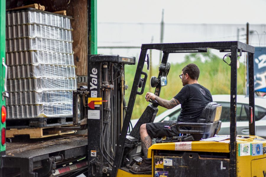 forklift loading beer cans into truck