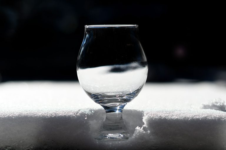 Empty glass of beer in snow