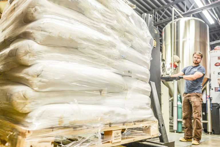 bags of malt wrapped on a pallet