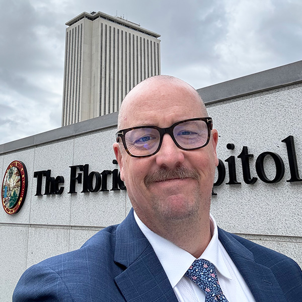 state government affairs leader in front of florida capitol