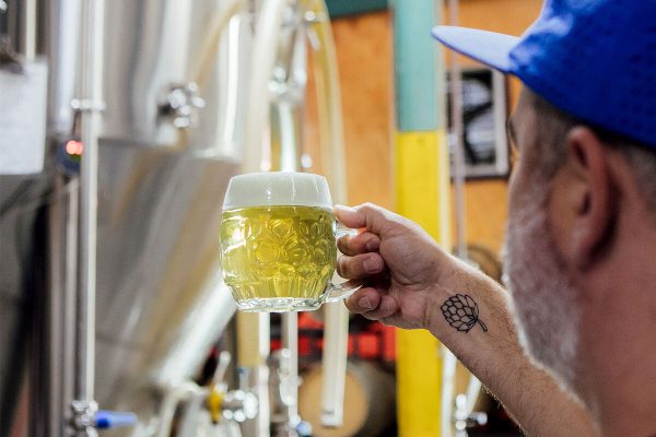 brewery worker with a mug of beer