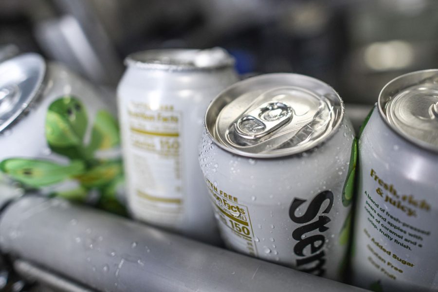 cans of cider on canning line
