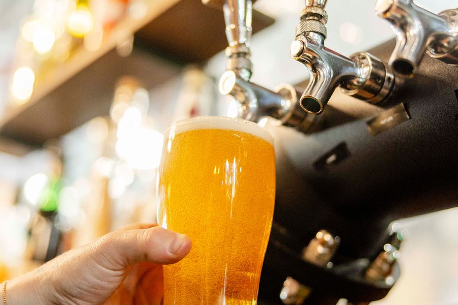 Hazy beer being pouring from tap