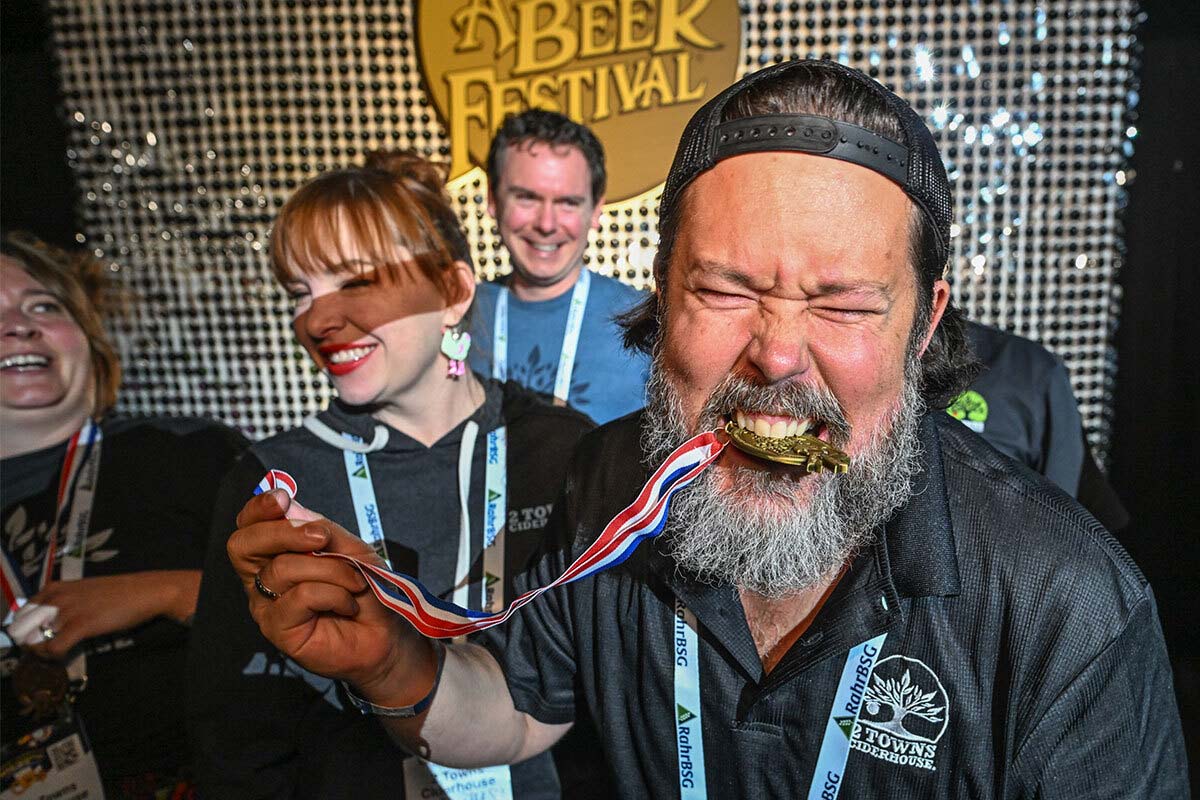 Ecstatic GABF winner with gold medal in his mouth