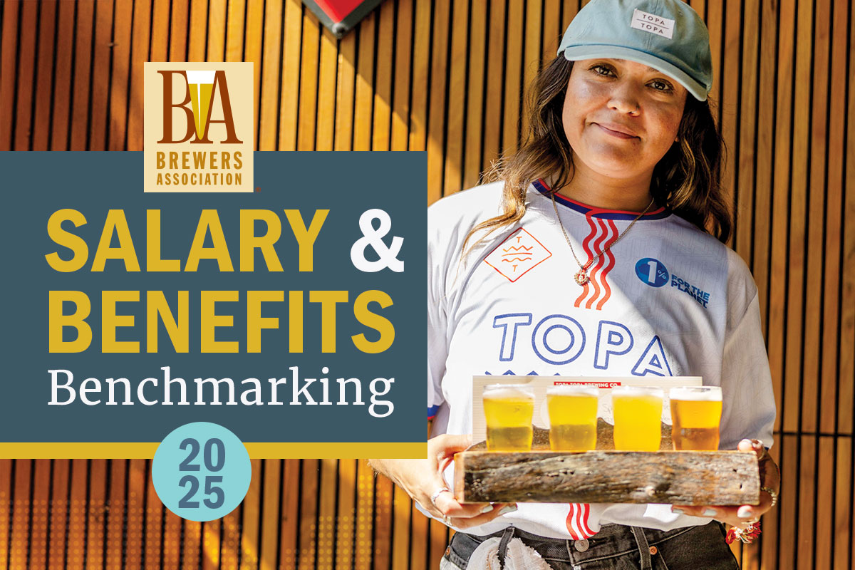 woman smiling at the camera holding beer tasters