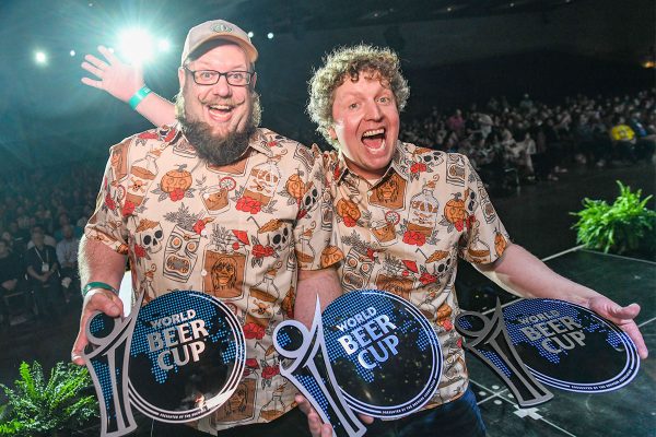 Two happy men on stage after winning world beer cup awards.
