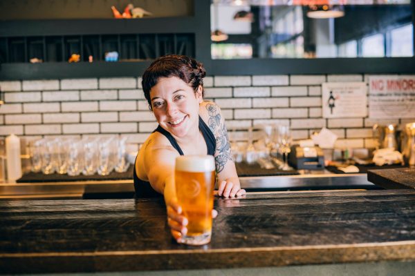 beertender offering a pint
