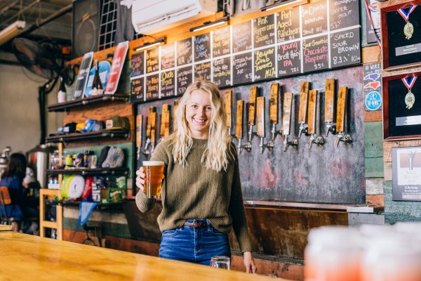 taproom worker serving beer