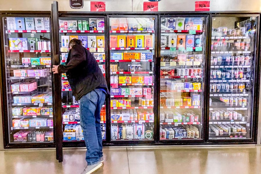 A man buying non-alcohol beer at a beer store.