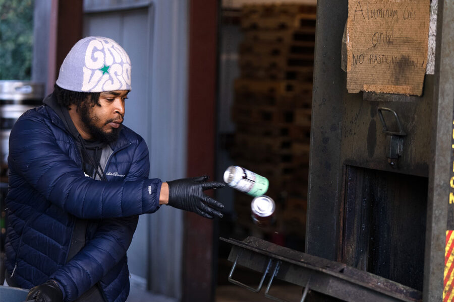 A craft brewer recycling an aluminum can