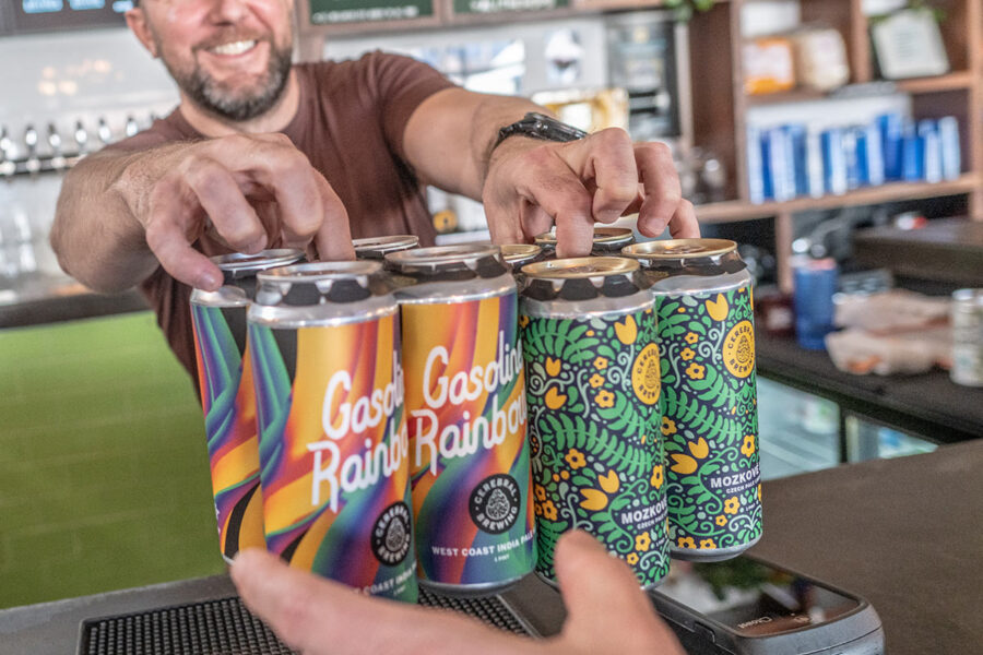 Bartender passing craft beers across a bar