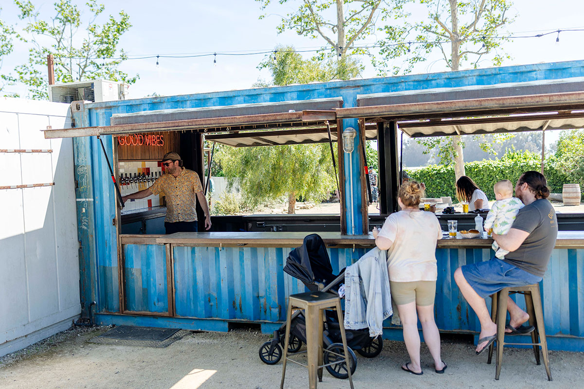 A man pouring beer in an outdoor taproom