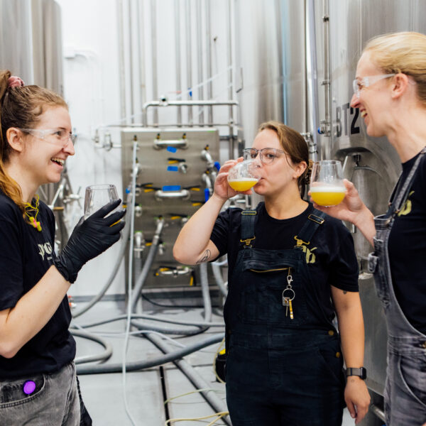 woman brew team beer sample talking