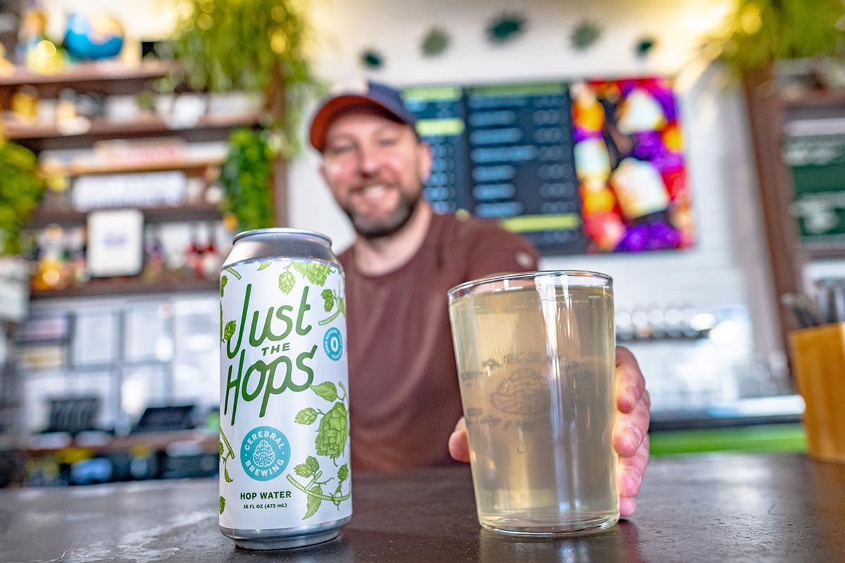 a bartender pusing hop water on a bar