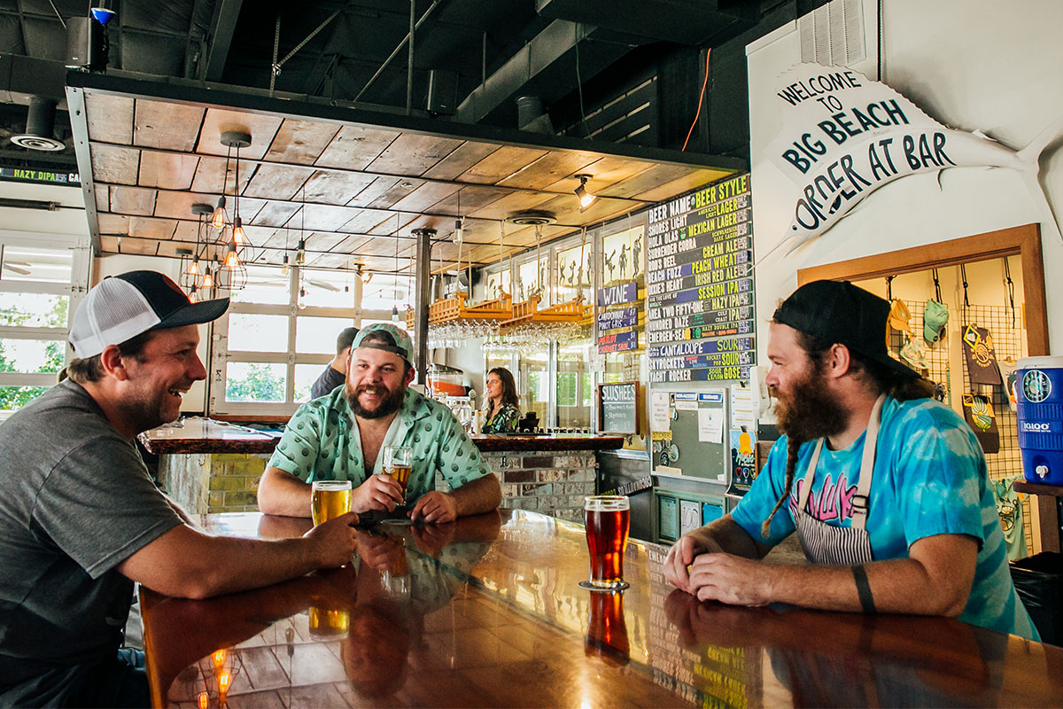 3 people enjoying craft beer in a brewery