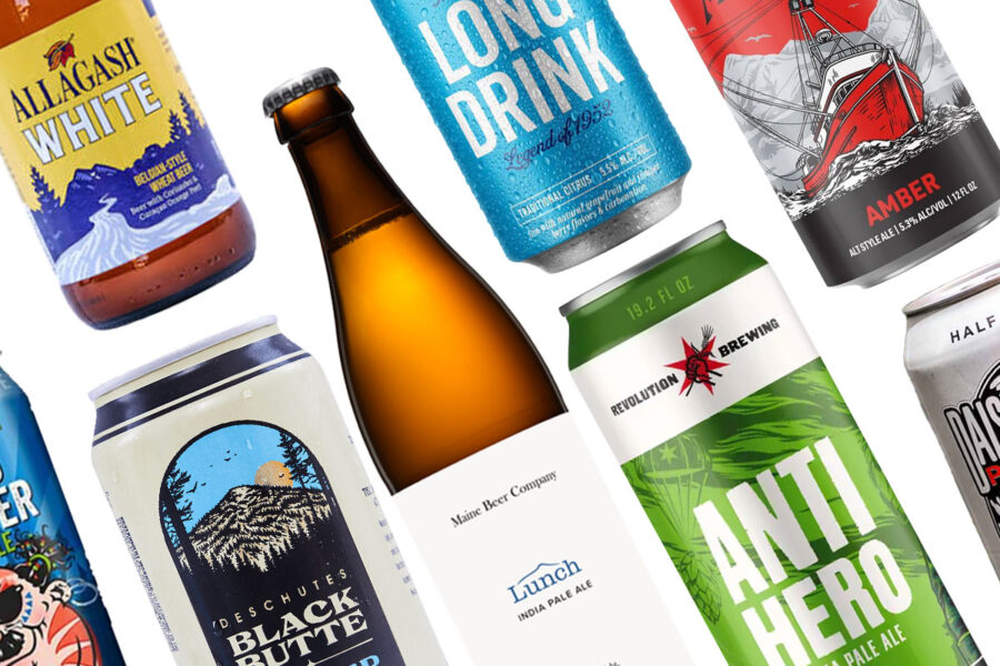 Variety of packaged beer in bottles and cans against white background