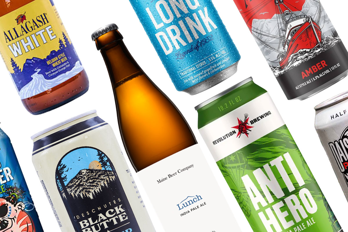 Variety of packaged beer in bottles and cans against white background